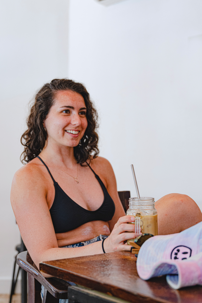 Woman enjoying a Cold  Brew Coffee in Tamarindo, Derecho Sagrado specialty coffee shop