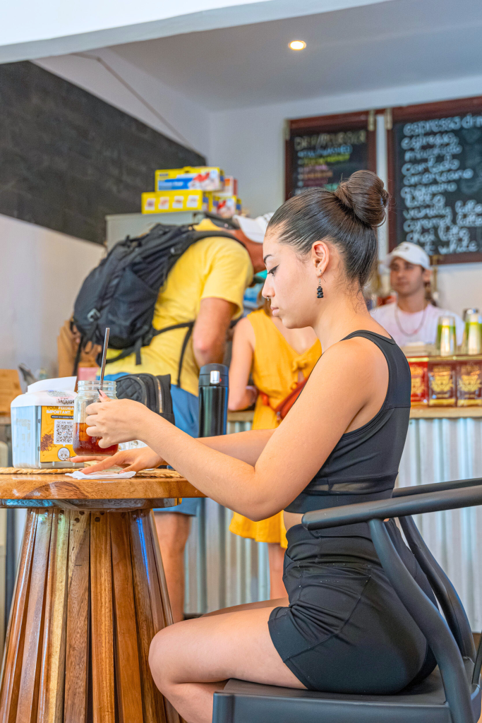 Woman enjoying a Cold  Brew Coffee in Tamarindo, Derecho Sagrado specialty coffee shop